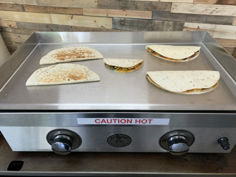 quesadillas cooking on the griddle