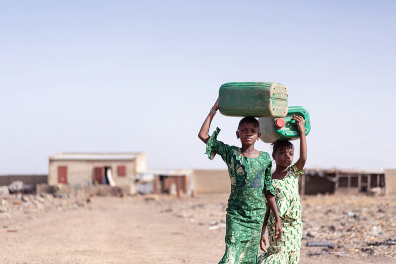getting-clean-water-1 two Ethiopian girls taking tanks to a well for clean water